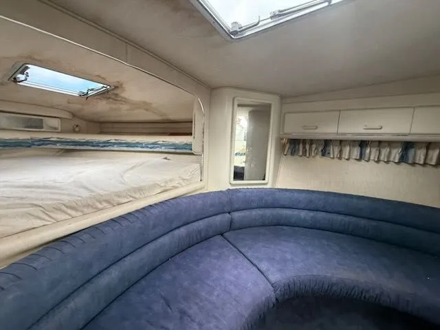 Slide: The Image of Interior of a 1993 Sea Ray 38 Express with blue upholstery. - 30