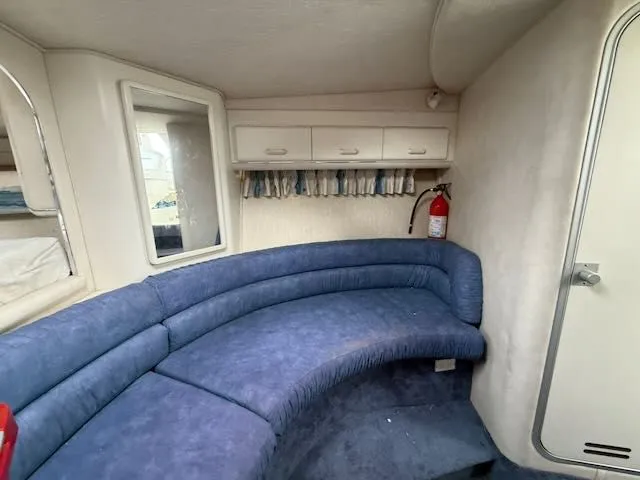 Slide: The Image of 1993 Sea Ray 38 Express interior with blue seating area. - 31