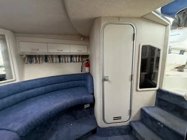 Slide: The Image of Interior of a 1993 Sea Ray 38 Express with blue upholstery. - 32