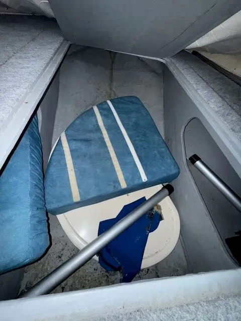 Slide: The Image of Interior of a 1993 Sea Ray 38 Express with blue cushions. - 34