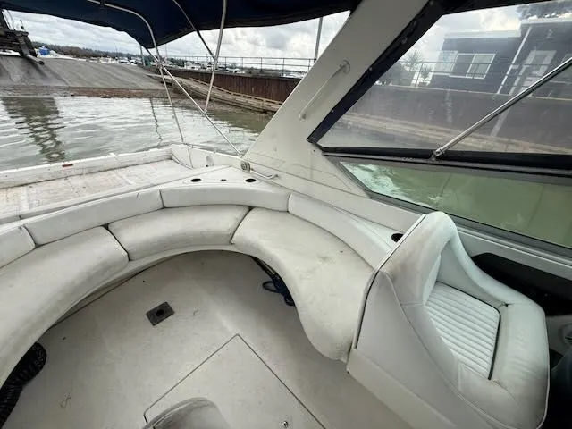 Slide: The Image of Interior of a 1993 Sea Ray 38 Express yacht with white seating. - 9