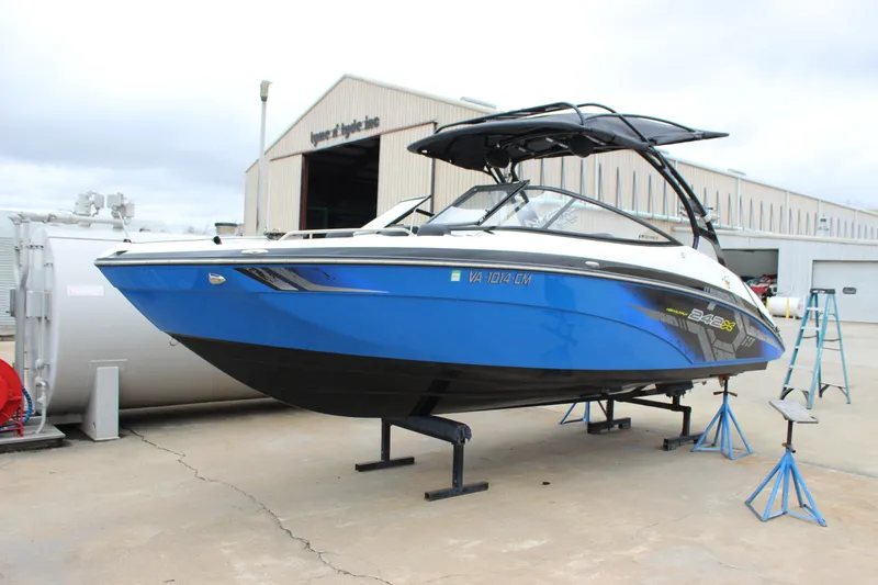 The Image of 2017 Yamaha Boats 242 Limited S E-Series in blue, displayed on stands outdoors. - 0
