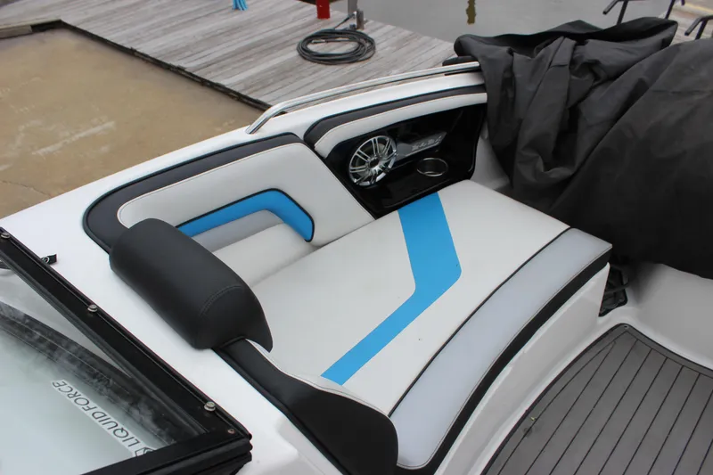 Slide: The Image of 2017 Yamaha Boats 242 Limited S E-Series interior seating with blue accents and speaker. - 17