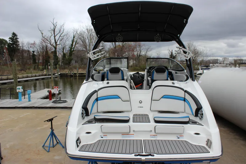 Slide: The Image of 2017 Yamaha Boats 242 Limited S E-Series at dock, showcasing sleek design and spacious seating. - 24