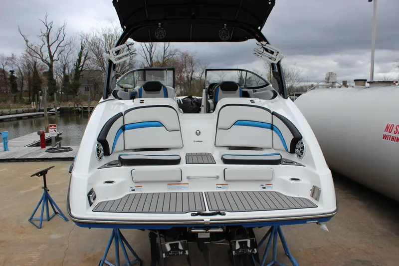 Slide: The Image of 2017 Yamaha Boats 242 Limited S E-Series on a dock, showcasing rear seating and sleek design. - 25