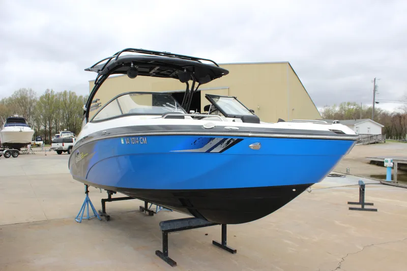 Slide: The Image of 2017 Yamaha Boats 242 Limited S E-Series in blue, displayed on a stand outdoors. - 3