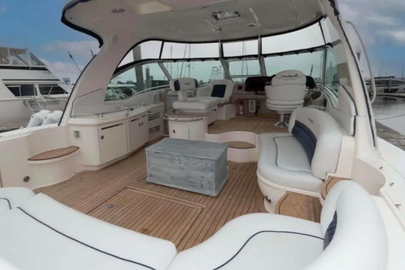 Slide: The Image of Luxurious 2005 Sea Ray 500 Sundancer yacht interior with elegant seating and wooden flooring. - 1
