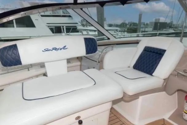 Slide: The Image of Luxurious seating on 2005 Sea Ray 500 Sundancer yacht, featuring elegant white and blue upholstery. - 11