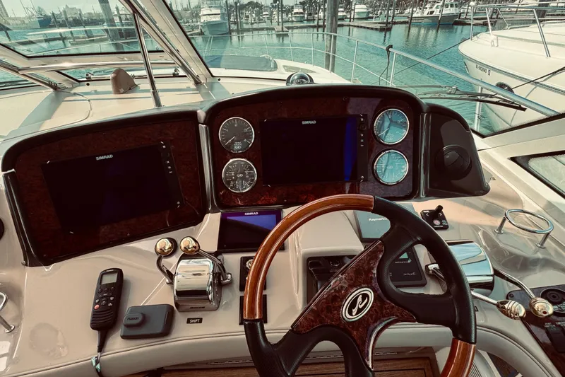 Slide: The Image of Helm of 2005 Sea Ray 500 Sundancer yacht with navigation instruments and steering wheel. - 13