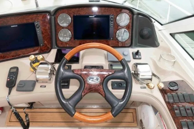 Slide: The Image of Helm of 2005 Sea Ray 500 Sundancer with wood-accented steering wheel and modern controls. - 15