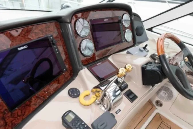 Slide: The Image of Dashboard of a 2005 Sea Ray 500 Sundancer yacht with navigation instruments. - 16