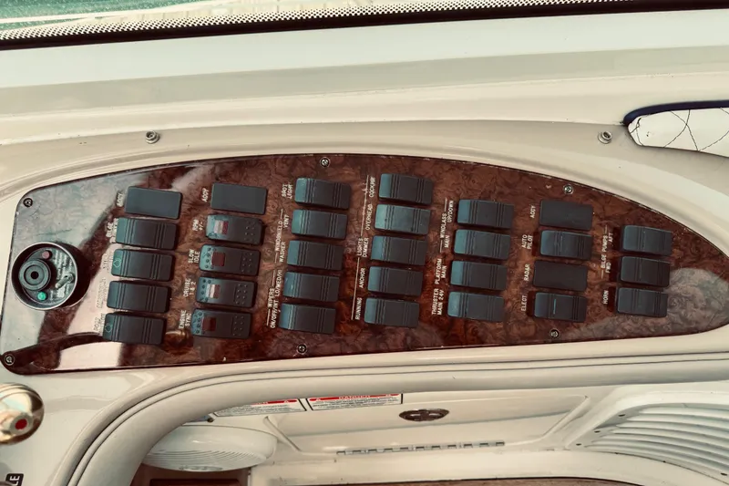 Slide: The Image of Control panel of a 2005 Sea Ray 500 Sundancer boat with multiple switches. - 17