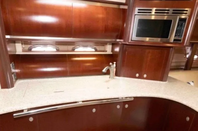 Slide: The Image of Luxurious kitchen area in a 2005 Sea Ray 500 Sundancer yacht with wood cabinetry. - 21