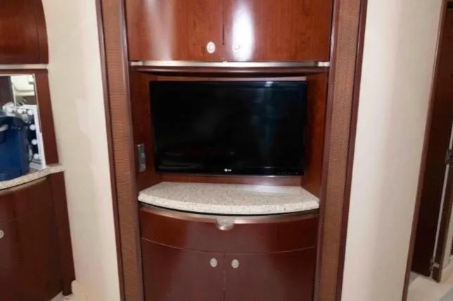 Slide: The Image of Interior of 2005 Sea Ray 500 Sundancer with TV and wooden cabinetry. - 24