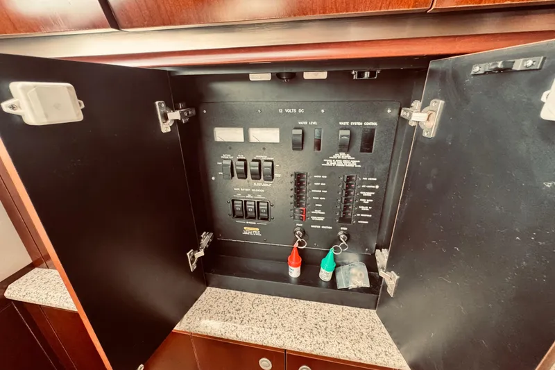 Slide: The Image of Electrical panel inside a 2005 Sea Ray 500 Sundancer yacht, featuring switches and controls. - 25
