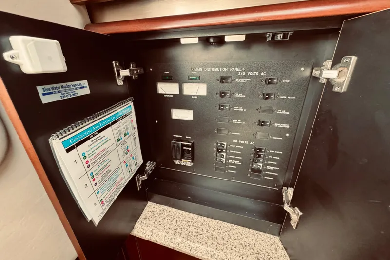 Slide: The Image of Electrical panel inside a 2005 Sea Ray 500 Sundancer yacht, featuring various switches and instructions. - 26