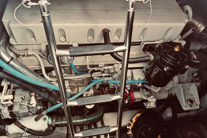 Slide: The Image of Engine compartment of a 2005 Sea Ray 500 Sundancer with visible components and ladder. - 31