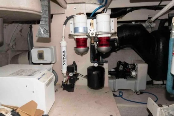 Slide: The Image of Engine room of 2005 Sea Ray 500 Sundancer with fuel filters and mechanical components. - 33
