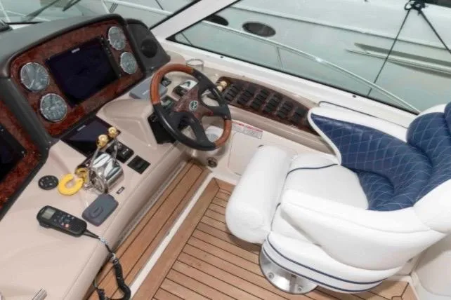 Slide: The Image of Helm of 2005 Sea Ray 500 Sundancer with wood accents and plush seating. - 5