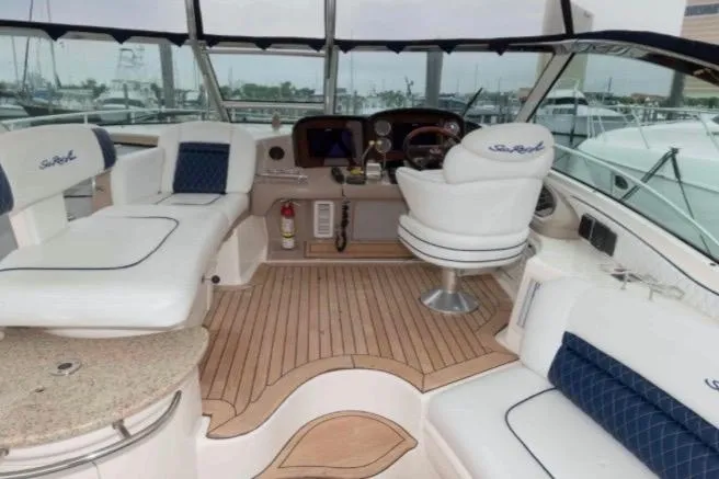 Slide: The Image of 2005 Sea Ray 500 Sundancer yacht interior with plush seating and elegant wood flooring. - 8