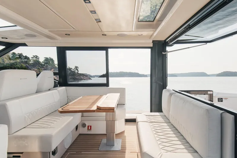 Slide: The Image of Interior of 2026 Saxdor 400 GTC yacht with elegant seating and scenic water view. - 7