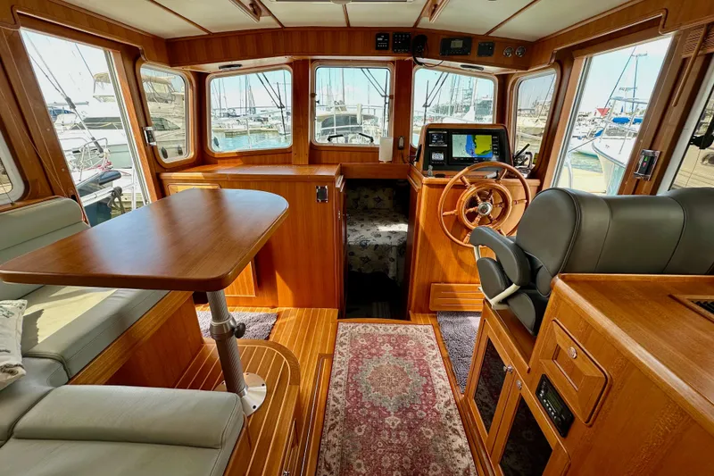 Slide: The Image of Interior of 2016 Helmsman Trawlers 38 Pilothouse with wood finish and navigation equipment. - 15