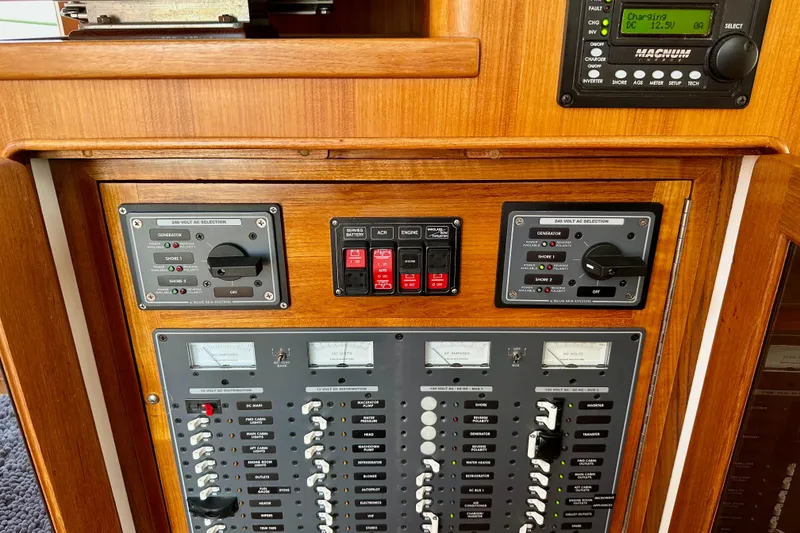 Slide: The Image of Control panel of 2016 Helmsman Trawlers 38 Pilothouse with switches and meters. - 22