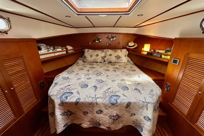 Slide: The Image of Cozy cabin interior of 2016 Helmsman Trawlers 38 Pilothouse with nautical-themed bedding. - 23