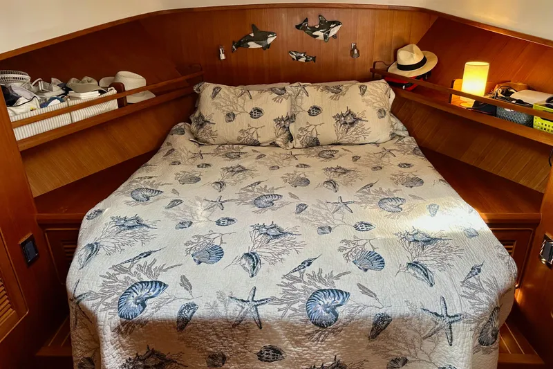 Slide: The Image of Cozy cabin bedroom in 2016 Helmsman Trawlers 38 Pilothouse with nautical-themed bedding. - 24