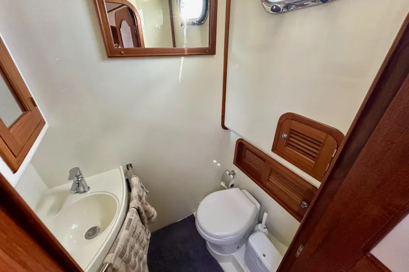 Slide: The Image of Compact bathroom in 2016 Helmsman Trawlers 38 Pilothouse, featuring sink and toilet. - 25
