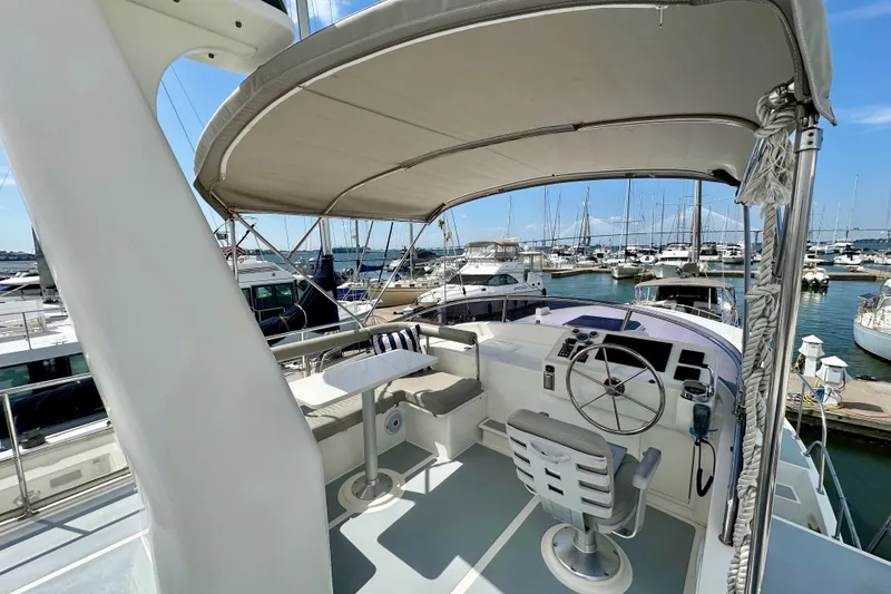 Slide: The Image of Helmsman Trawlers 38 Pilothouse 2016, featuring a spacious helm and marina view. - 33