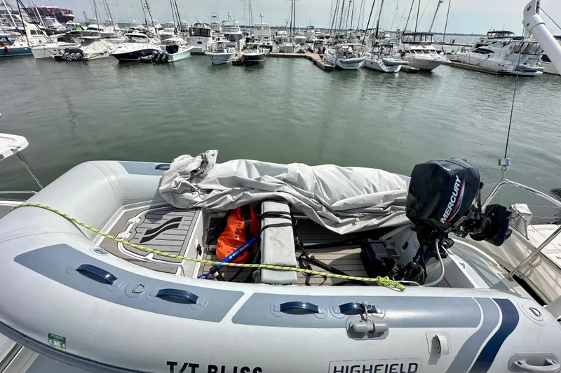 Slide: The Image of Inflatable boat with Mercury motor docked near Helmsman Trawlers 38 Pilothouse, 2016 model. - 38