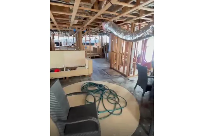 Slide: The Image of Interior renovation of 1985 Sterling Yachts 155 Motor Yacht, showing exposed framework and construction materials. - 13