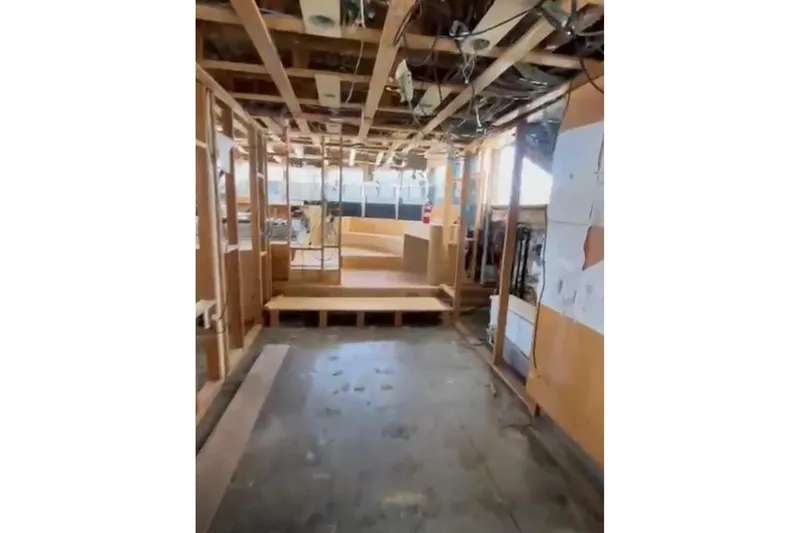 Slide: The Image of Interior renovation of 1985 Sterling Yachts 155 Motor Yacht, showing exposed framework and wiring. - 16