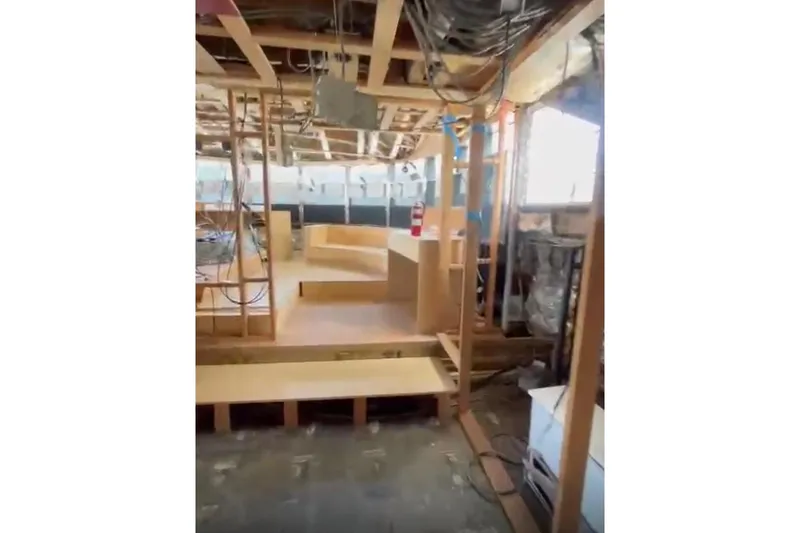 Slide: The Image of Interior construction of 1985 Sterling Yachts 155 Motor Yacht, showcasing wooden framework and wiring. - 17