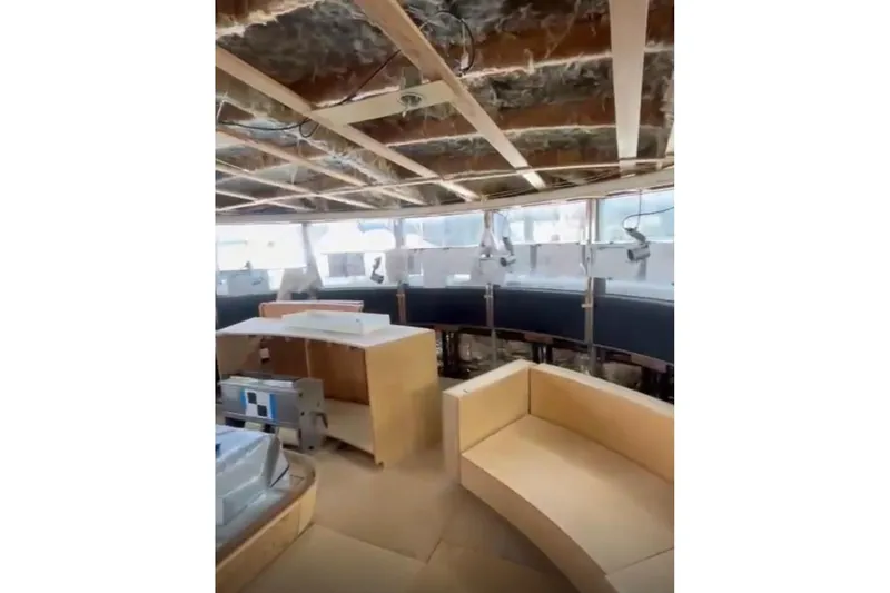Slide: The Image of Interior of a 1985 Sterling Yachts 155 Motor Yacht under renovation, featuring modern seating. - 19