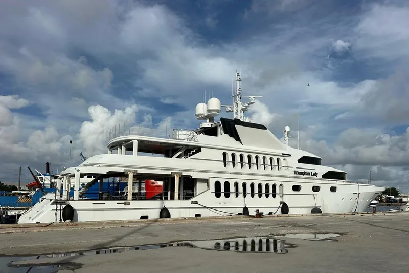 Slide: The Image of 1985 Sterling Yachts 155 Motor Yacht docked under a cloudy sky. - 2