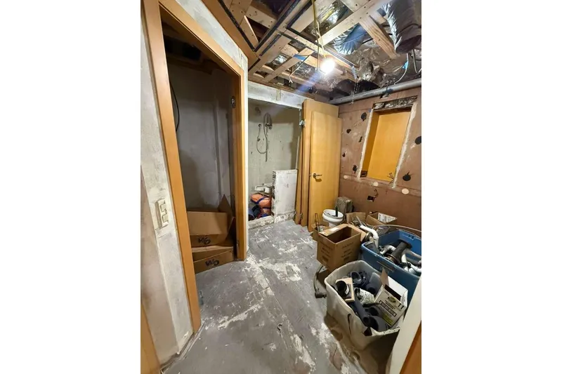 Slide: The Image of Interior of 1985 Sterling Yachts 155 Motor Yacht under renovation, showing storage and construction materials. - 26