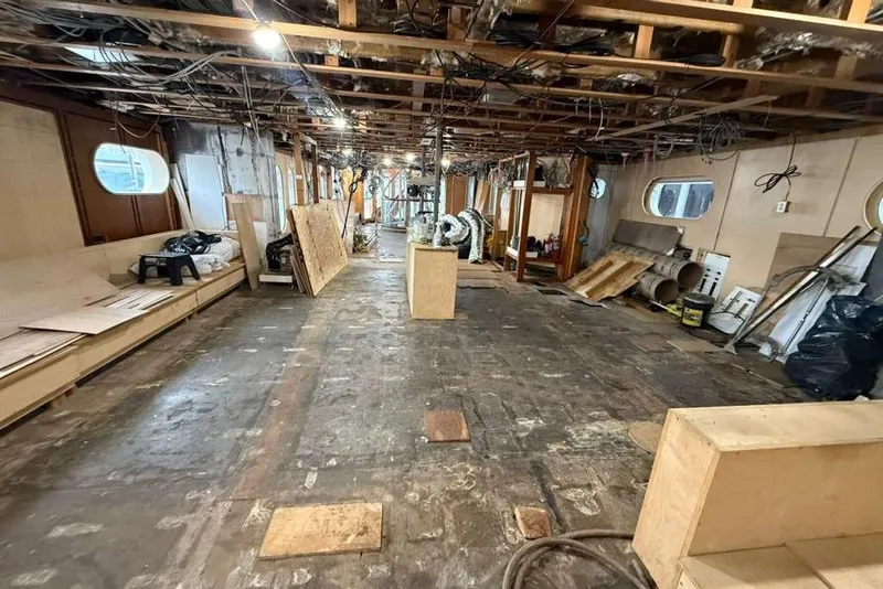 Slide: The Image of Interior renovation of 1985 Sterling Yachts 155 Motor Yacht, showing construction materials and exposed framework. - 32
