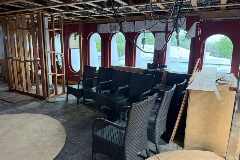 Slide: The Image of Interior renovation of 1985 Sterling Yachts 155 Motor Yacht with wicker chairs and wooden framework. - 36