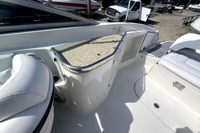 Slide: The Image of 2011 Monterey 254FSC boat interior with seating and storage area. - 13