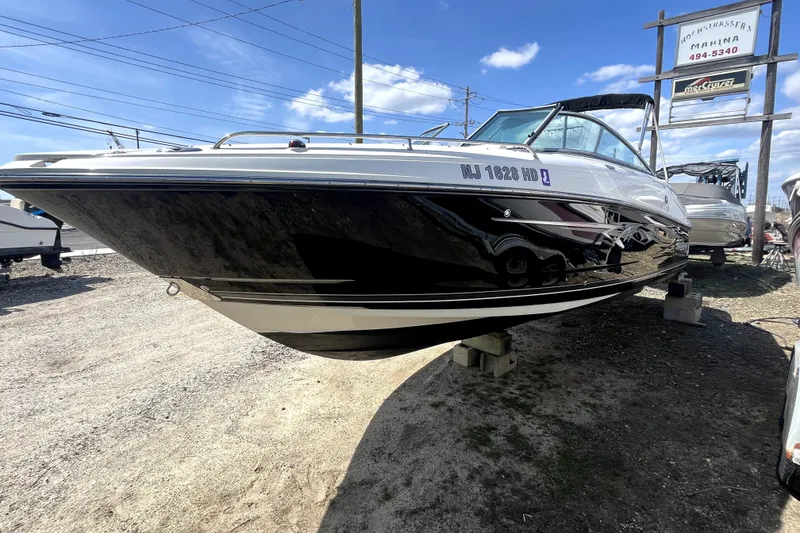 Slide: The Image of 2011 Monterey 254FSC boat displayed outdoors on a sunny day. - 2