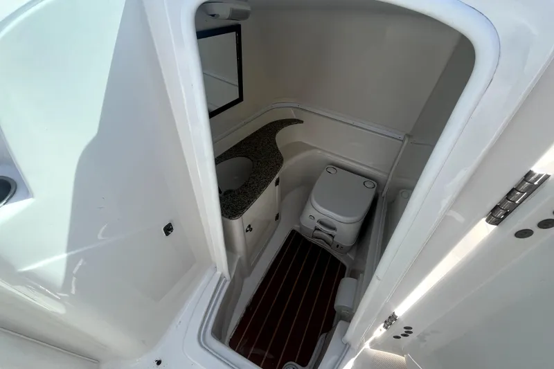 Slide: The Image of Interior of a 2011 Monterey 254FSC yacht with toilet and sink. - 25