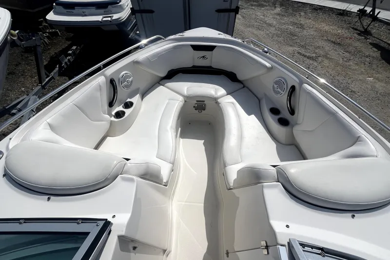 Slide: The Image of 2011 Monterey 254FSC boat interior with white seating and cup holders. - 27