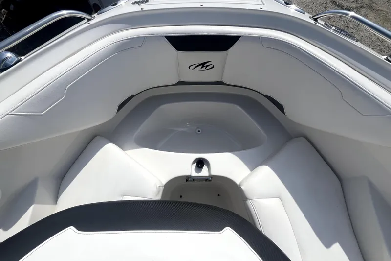 Slide: The Image of Interior view of a 2011 Monterey 254FSC boat, featuring white seating and sleek design. - 30
