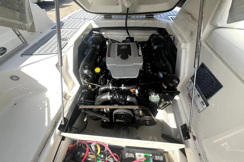 Slide: The Image of Engine compartment of a 2011 Monterey 254FSC boat, showcasing the engine and components. - 32