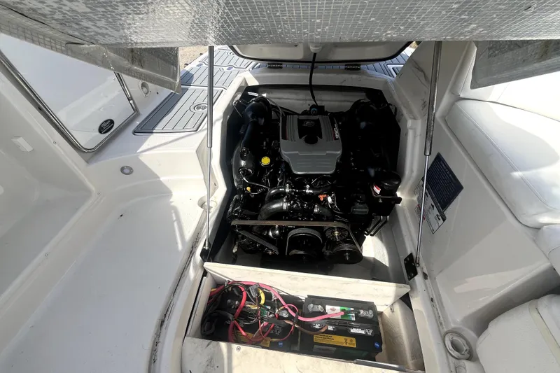 Slide: The Image of Engine compartment of a 2011 Monterey 254FSC boat, showcasing the engine and battery setup. - 33