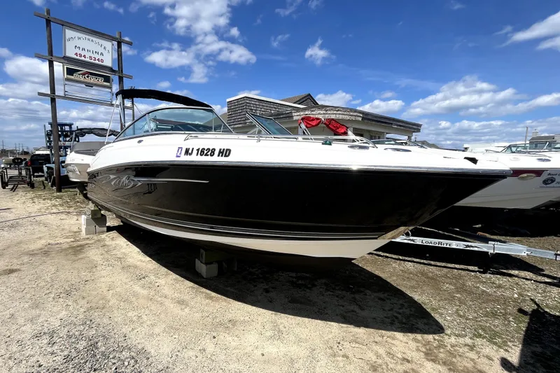 Slide: The Image of 2011 Monterey 254FSC boat displayed at a marina under a clear blue sky. - 1
