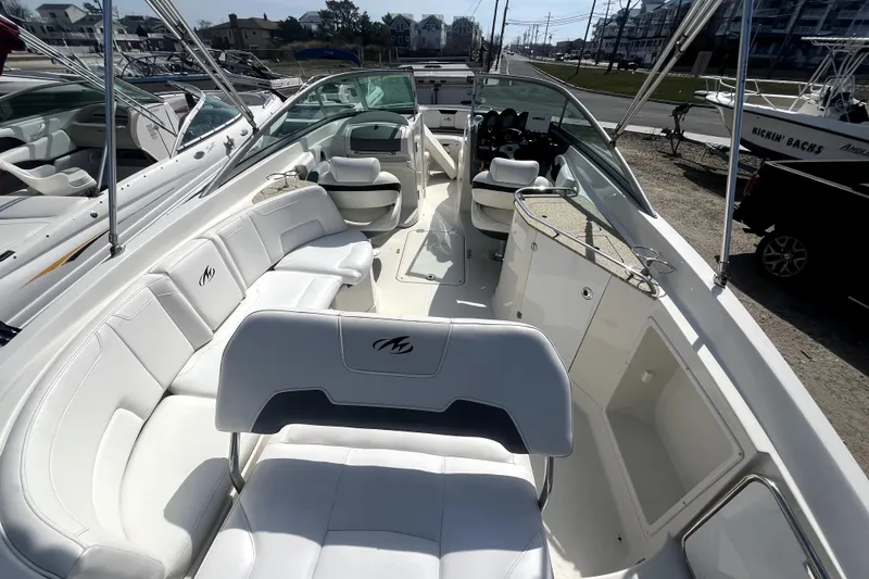 Slide: The Image of 2011 Monterey 254FSC boat interior with white seating and sleek design. - 11