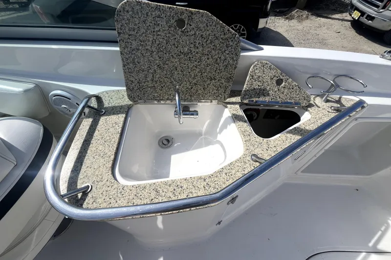 Slide: The Image of Granite countertop with sink on 2011 Monterey 254FSC boat, featuring stainless steel railings. - 14
